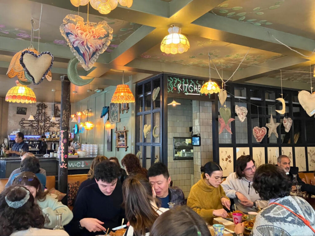 Crowd of people having lunch at Café Crème
