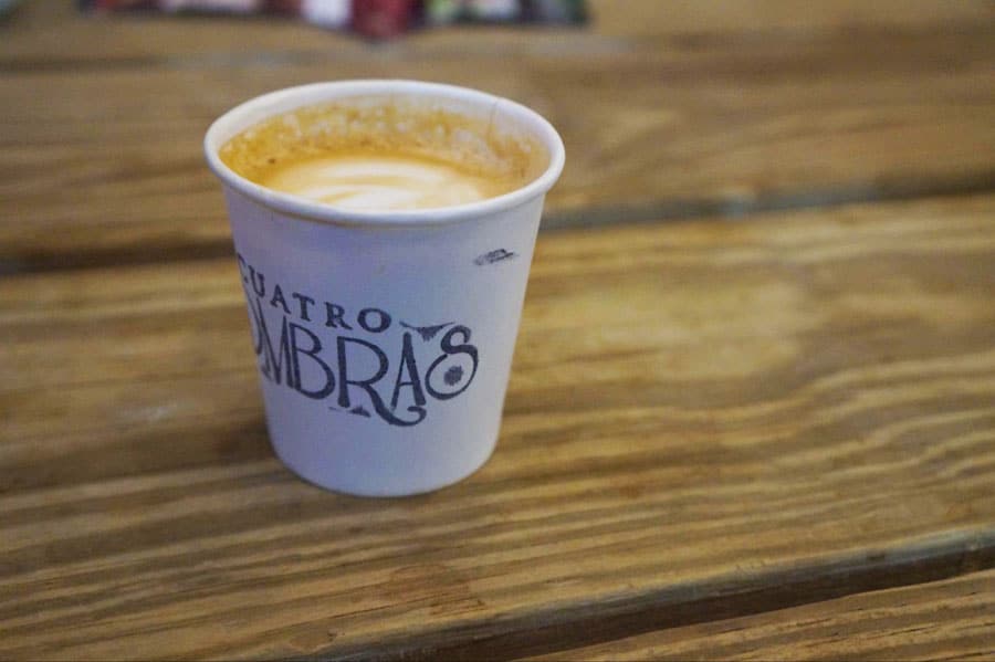 A cup of latte on table in Café Cuatro Sombras