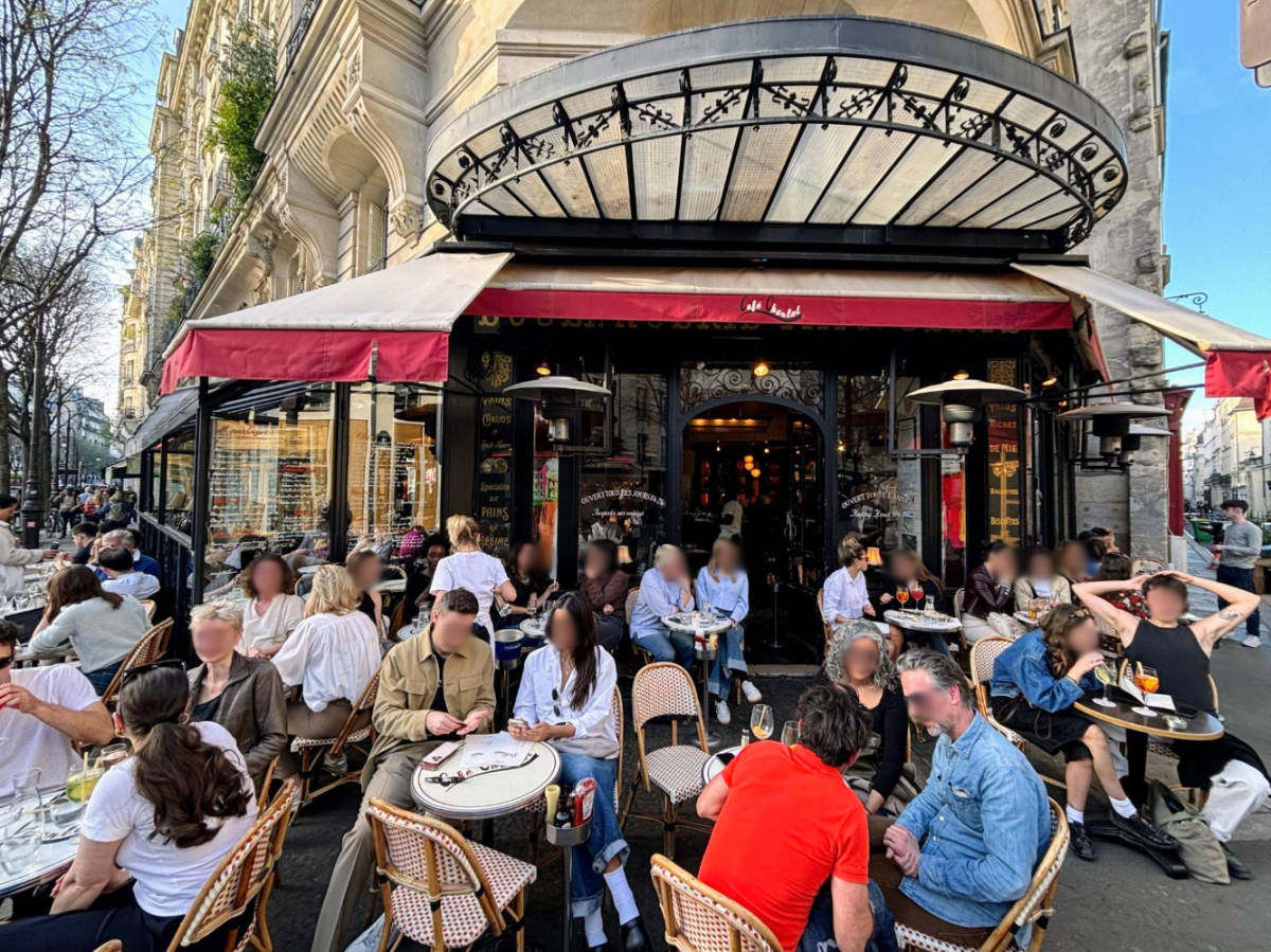 View of people outside a busy cafe in Paris