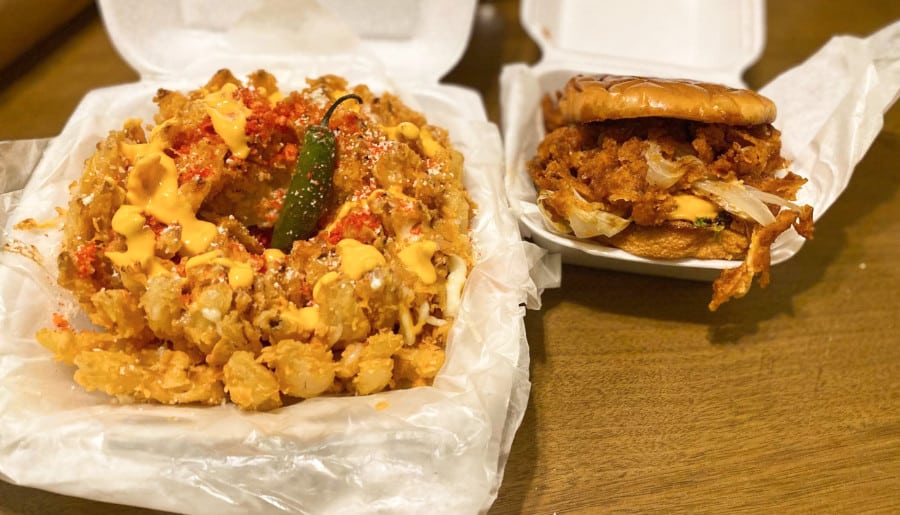 Deep-fried onions with melted cheese and burger in CaliBombs & Burgers.