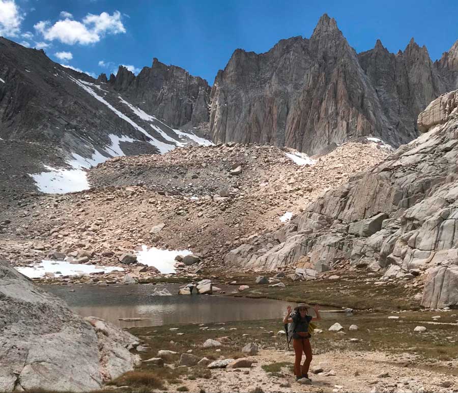 The author posing for a photo during her exploration in one of the California mountains