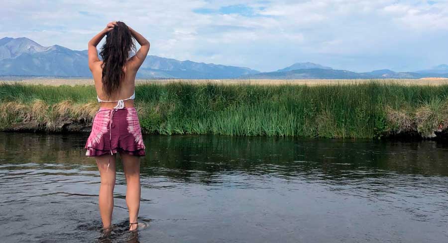 The author dipping her feet on a water in California
