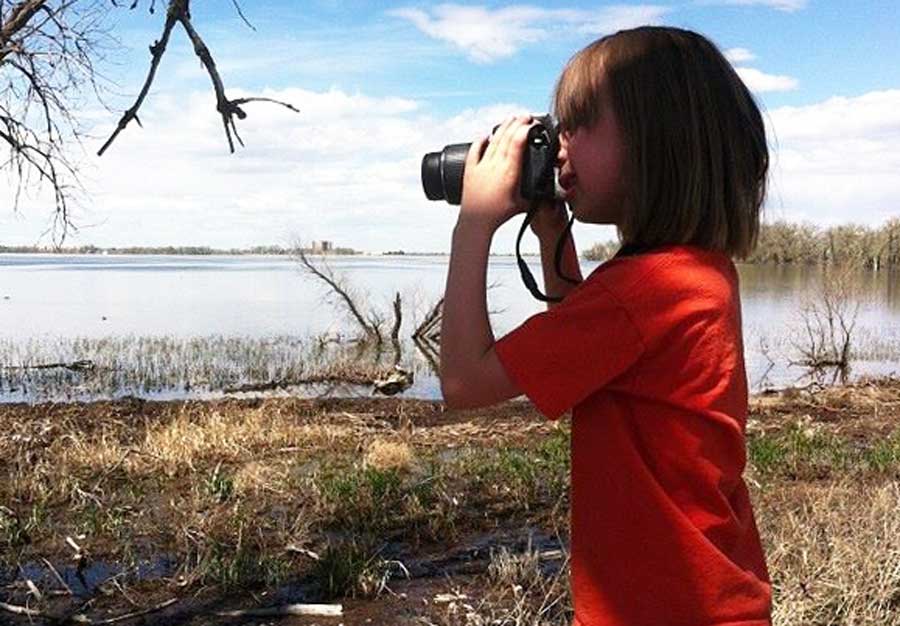 The author's kid using a kid-friendly camera during their trip