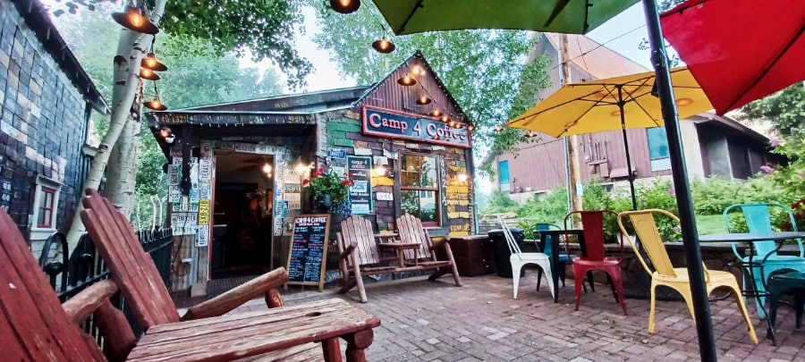 Colorful chairs and umbrellas outside the seating area of Camp 4 Coffee