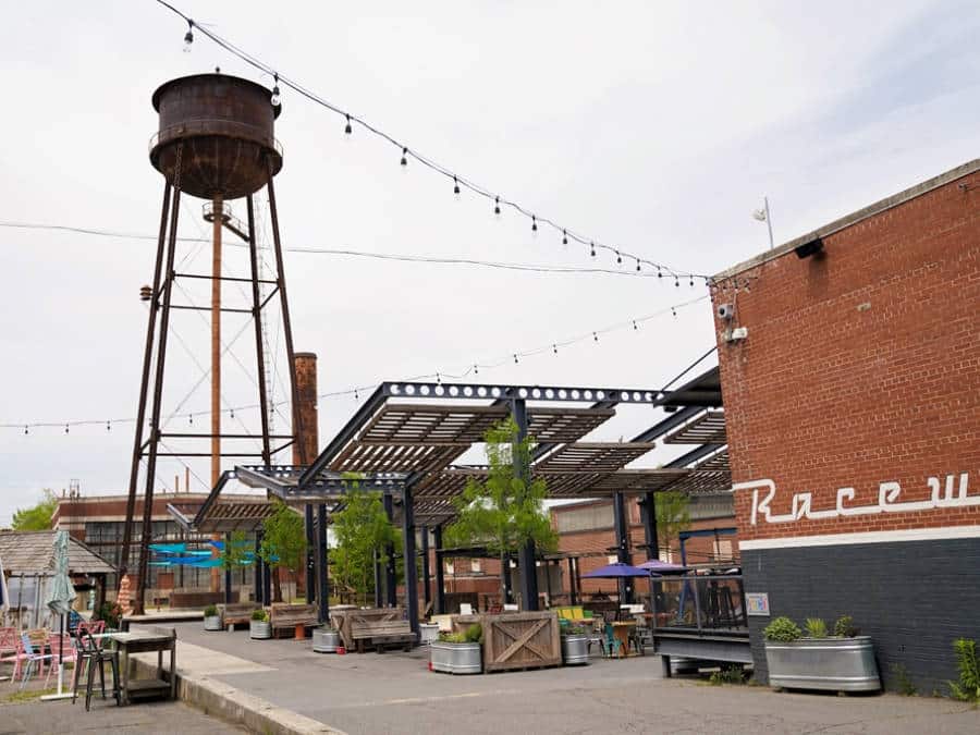 A water tank tower near an industrial area with outdoor seating