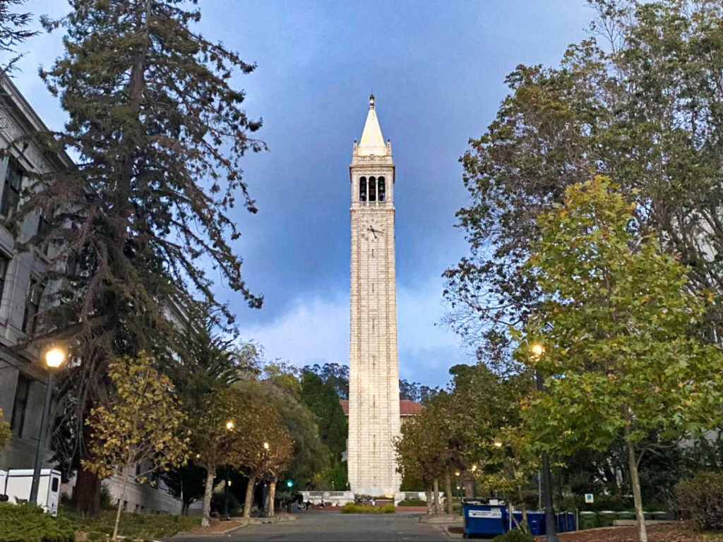 The famous Campanile clock tower surrounded by greenery at the UC Berkeley campus