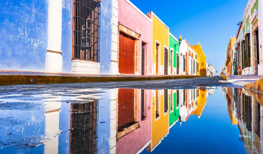 Colorful buildings in Campeche and its reflection on the street