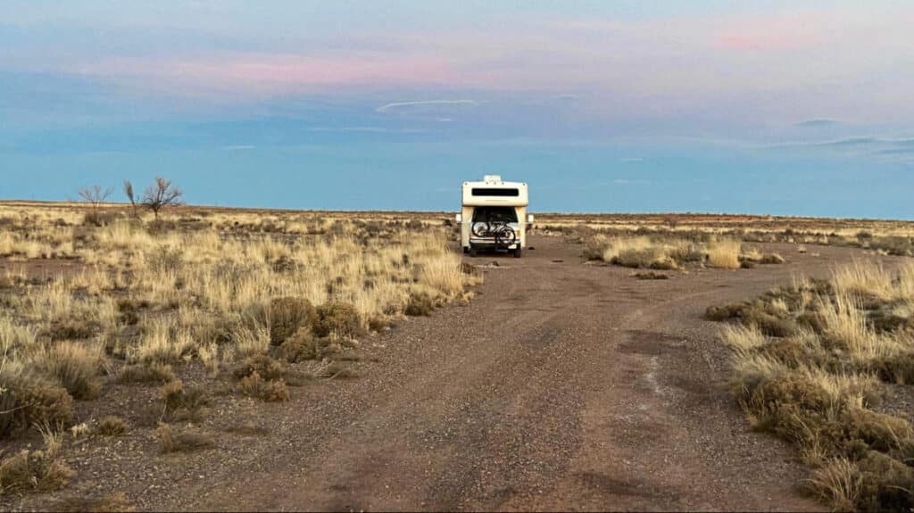A campervan in the middle of a campsite in Arizona with beautiful sunset view