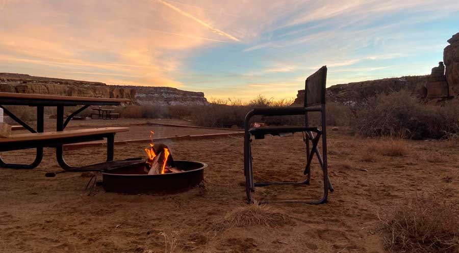 A camp chair and a camp fire at the Columbine Campground