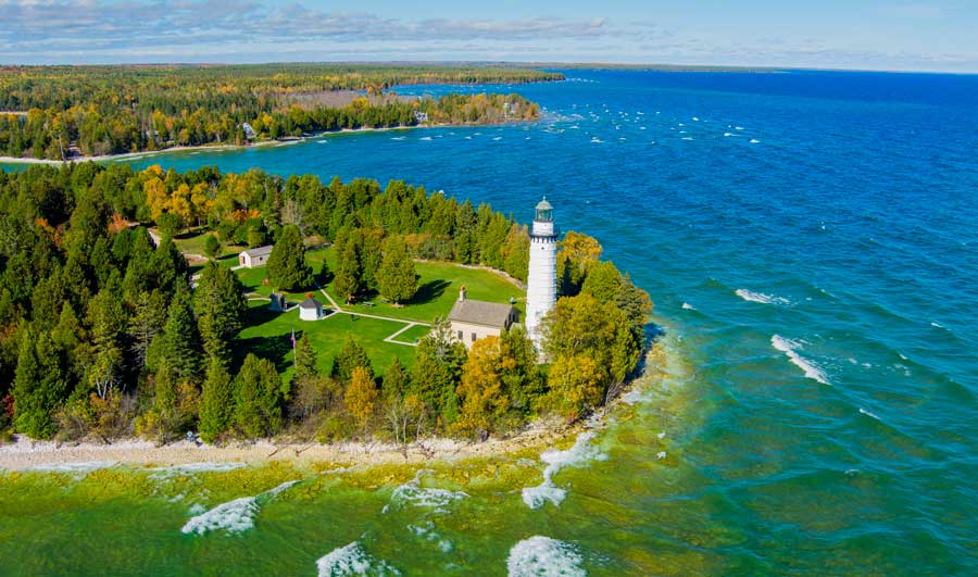 Aerial view of the Cana Island Lighthouse and the blue water around it
