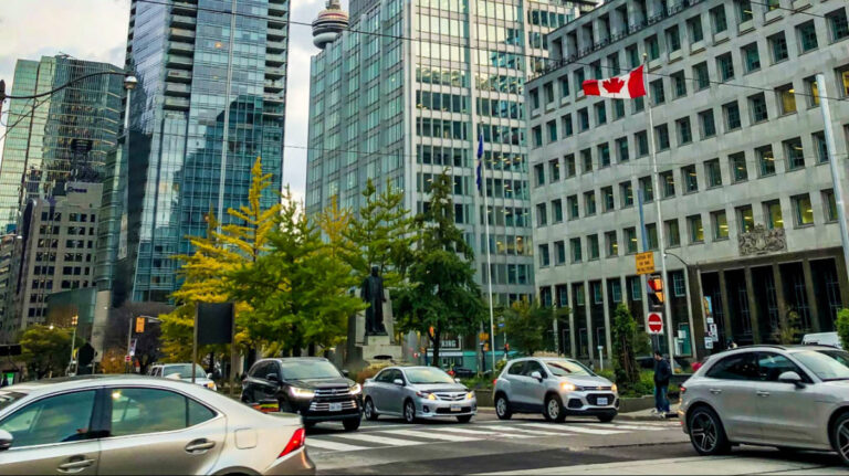 View of the buildings and cars driving along Downtown Toronto, Canada