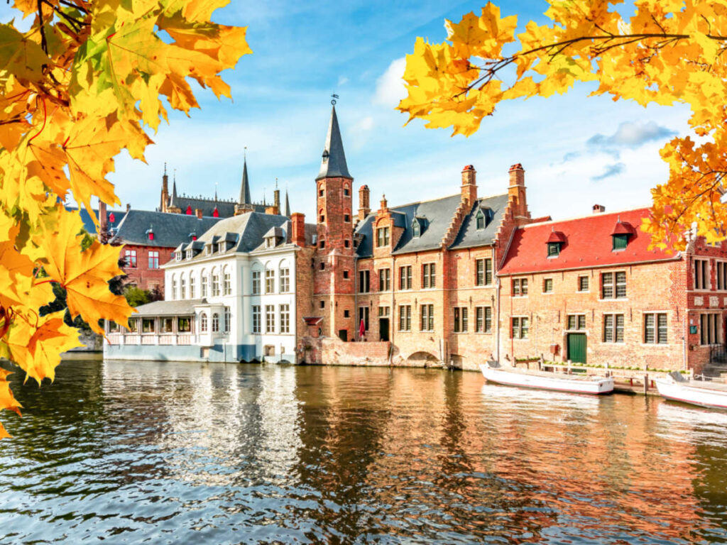 View of the fall foliage framing the colorful buildings near the canal