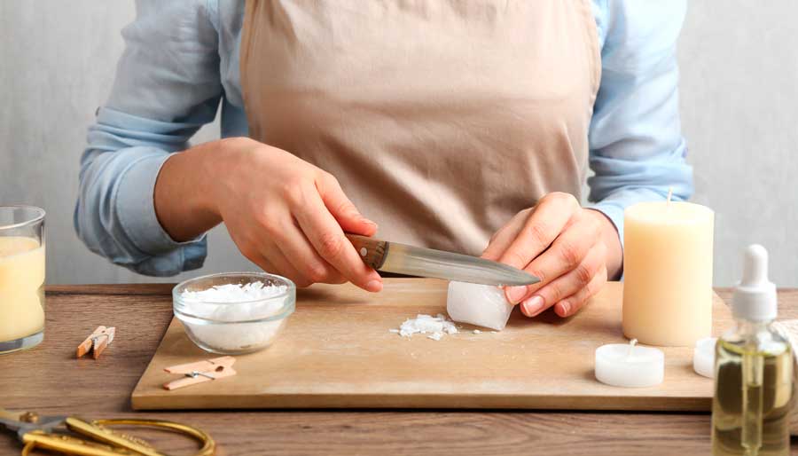 A lady making a candle by hand