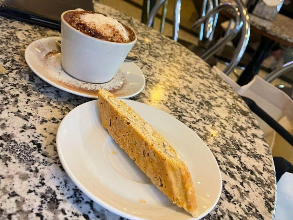 The Cappuccino and biscotti on the table at Caffe Vittoria