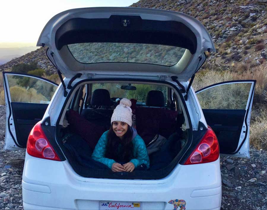 The author camping on her car in Death Valley National Park