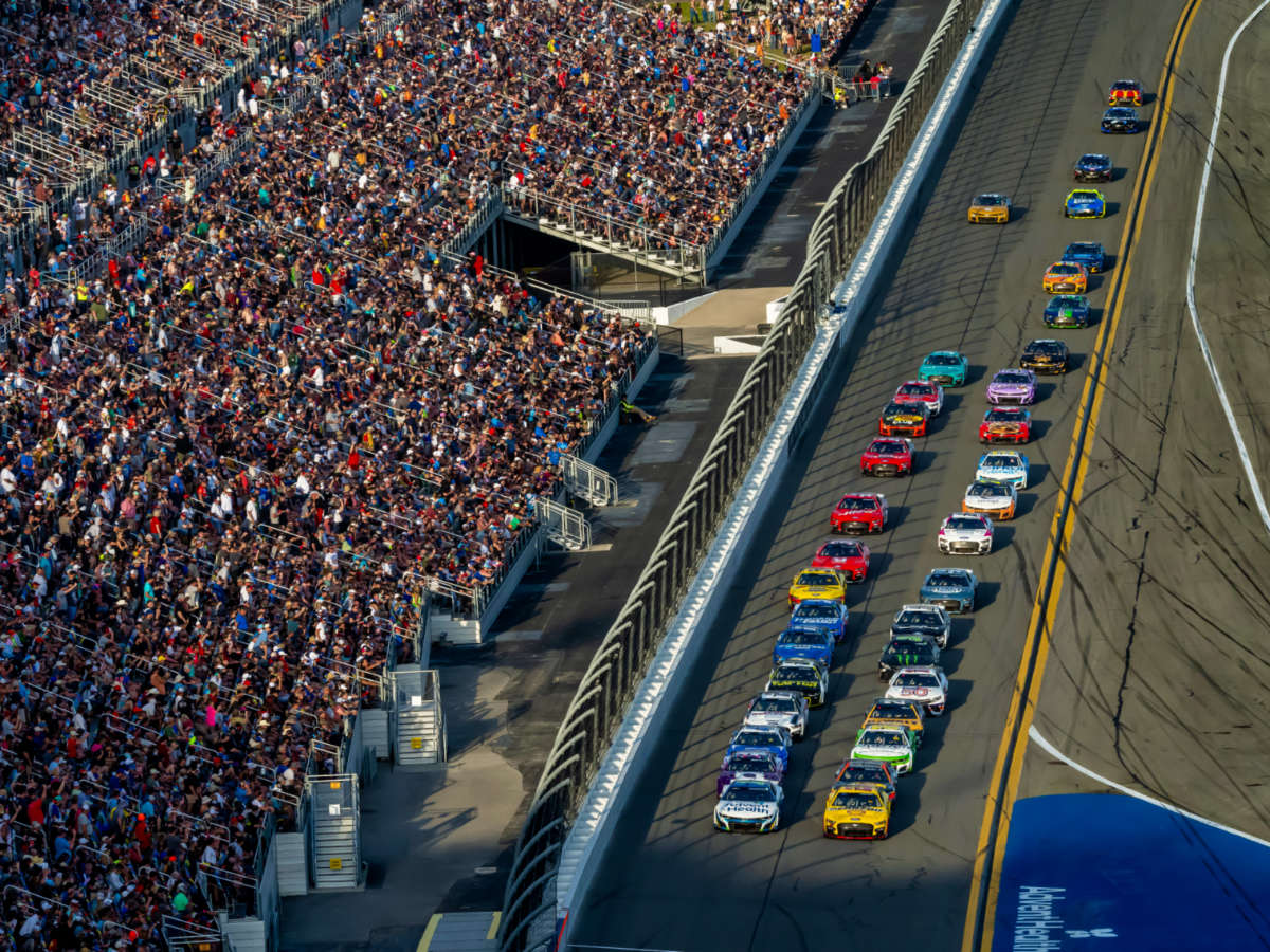 Aerial view of the crowd watching the Daytona 500 car racing on the track at Daytona International Speedway