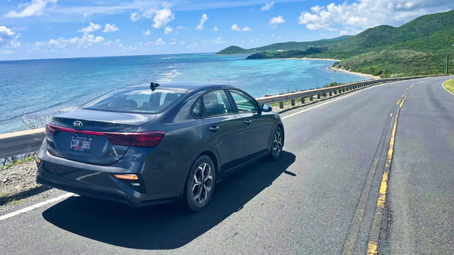 View of a car driving along the highway with a scenic coastal view of St. Croix