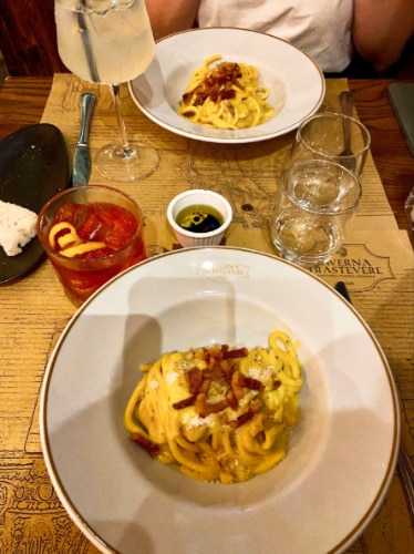 Two plates of the famous carbonara from Taverna Trastevere