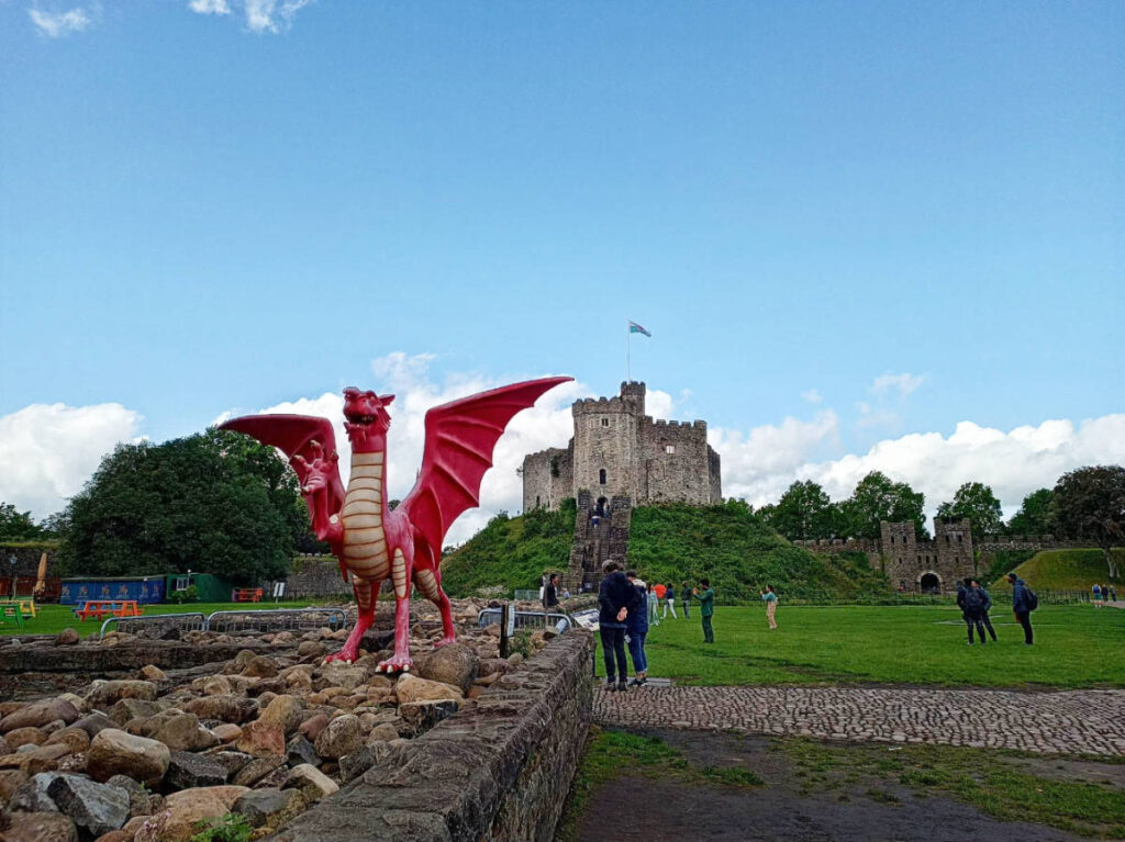 Clear blue sky over the Cardiff Castle and a dragon statue
