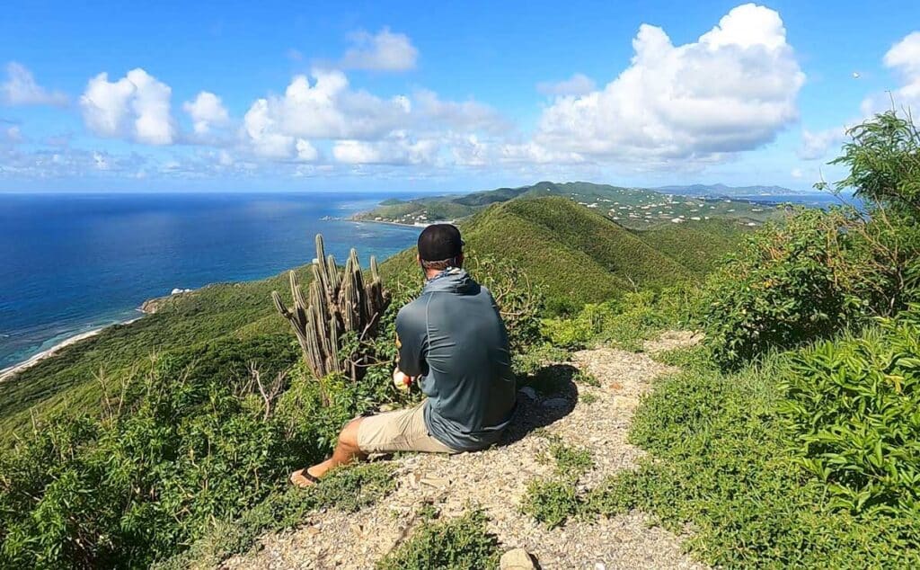 Travel Lemming writer Andrew admiring the view of Caribbean Sea from the top of Goat Hill