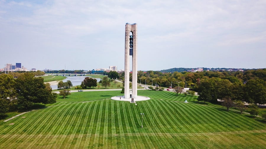 The tall bell tower in the middle of green space in Carillon Historical Park