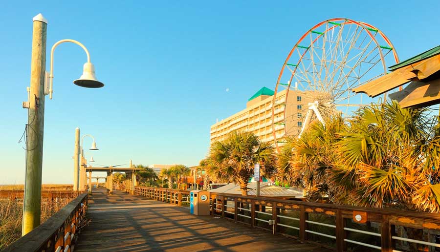 A ferris wheel can be seen in Carolina Beach Boardwalk