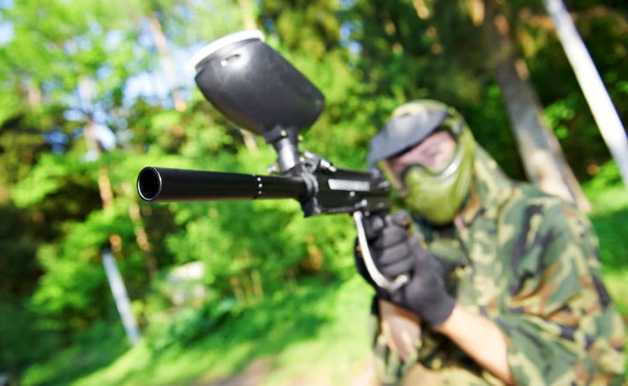 View of an aiming paintball player