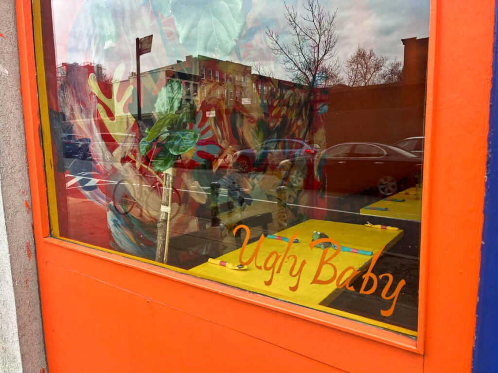 View of the window and the bright orange exterior of Carroll Gardens