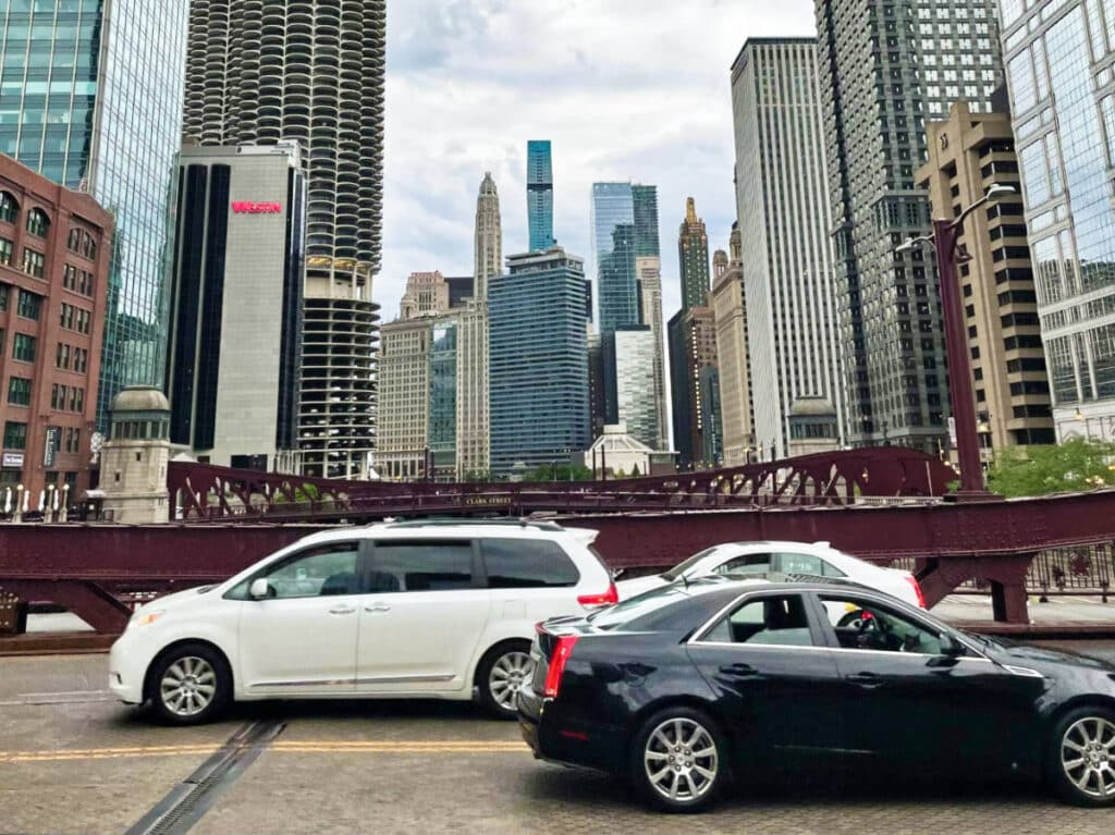 View of the cars driving over the Chicago River with the skyline in the background