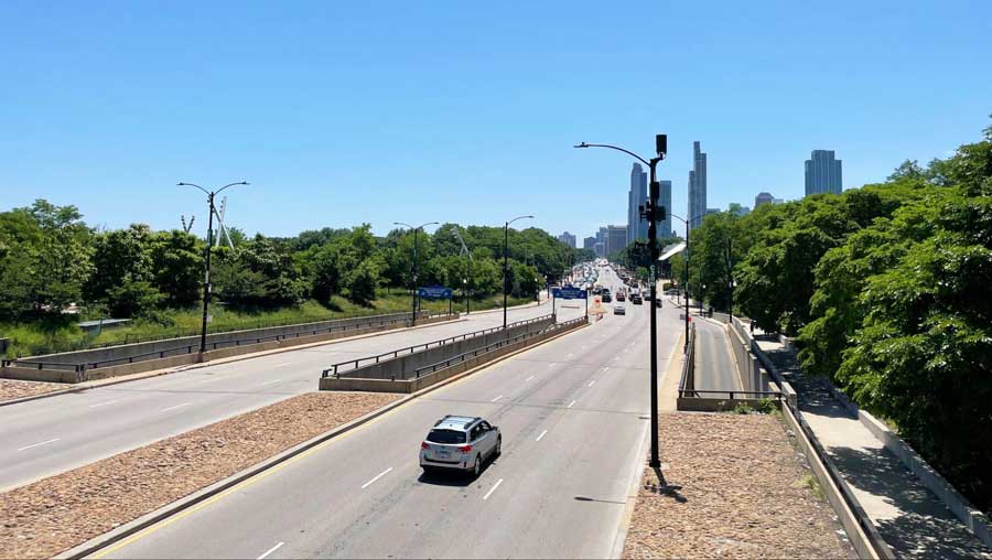 View of cars driving in Chicago under the clear blue sky