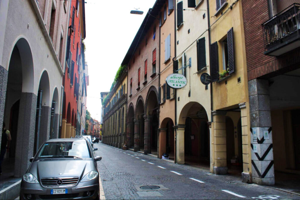 View of the cars parked at the side of the street in Bologna