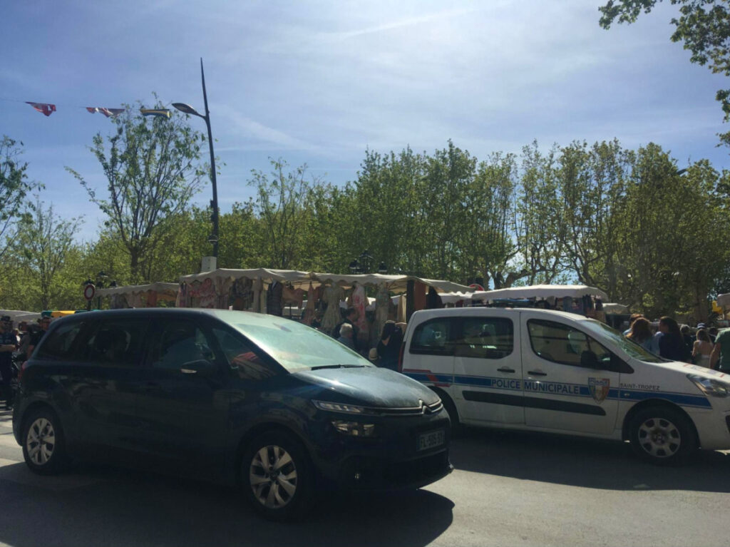 Private car and police car in the Les Lices area of Saint-Tropez
