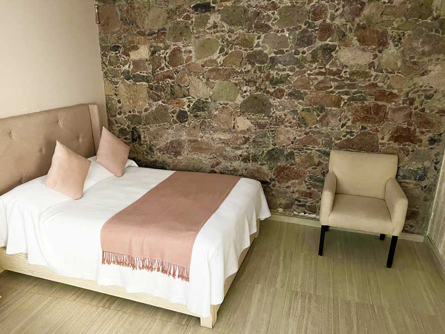 View of a bed and a couch in Casa Aliza