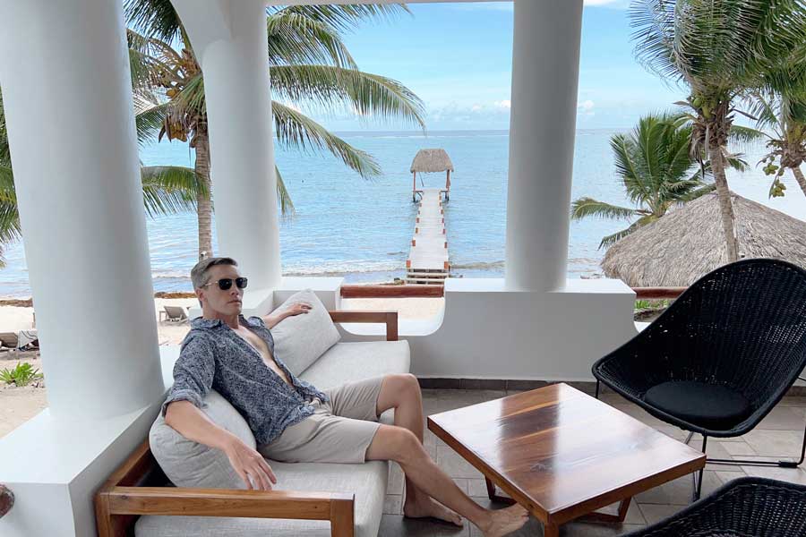 Nate relaxing on a couch with view from the beach in Casa Altamar