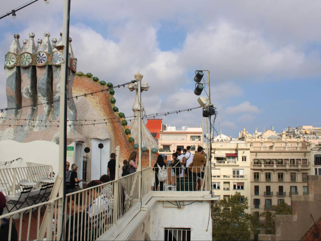 People at the Casa Batllo with an ovelooking view of Barcelona