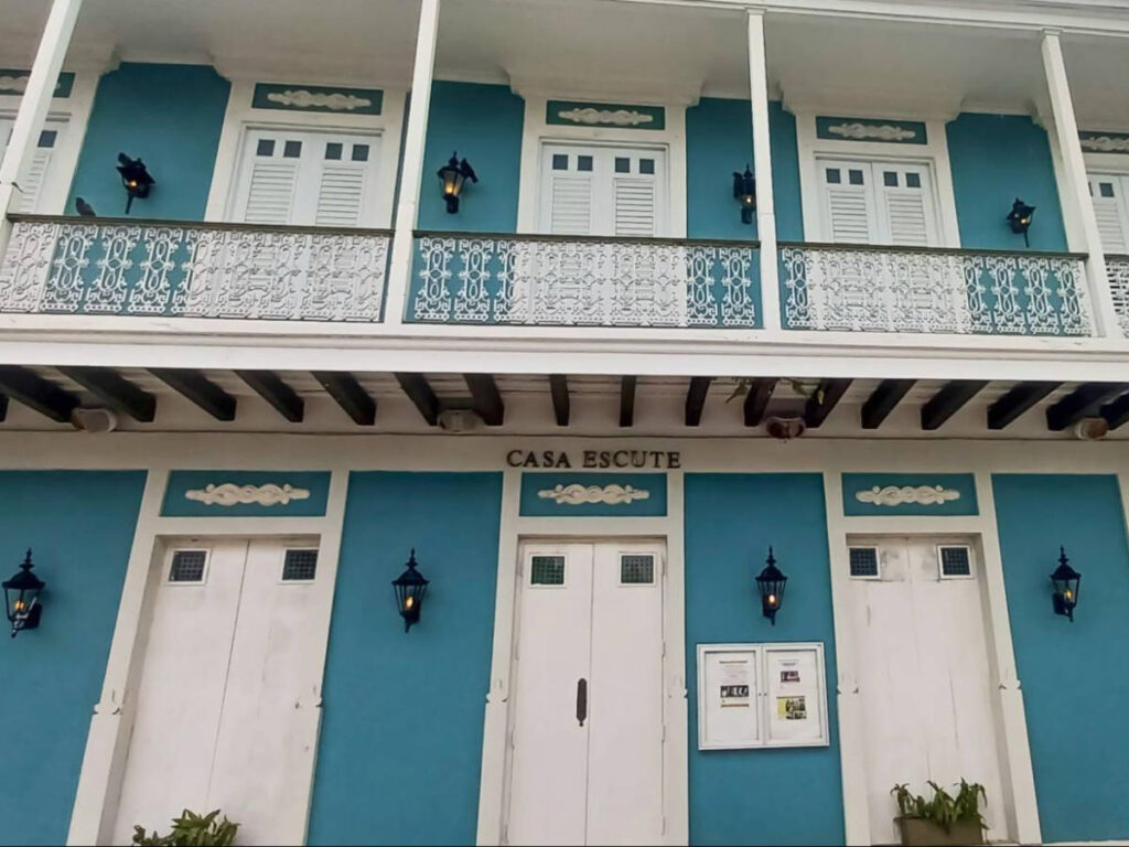 View of the bright blue facade of Casa Escuté