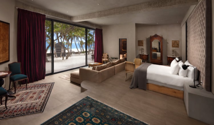 View of a hotel room with window opening to the Tulum beach