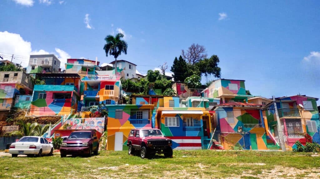 View of the parked vehicles below the colorful buildings at Casitas De Colores