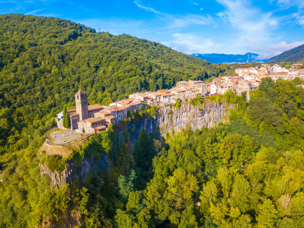 Aerial view of the medieval village of Castellfollit de la Roca on the rocky cliff in the middle of the forest