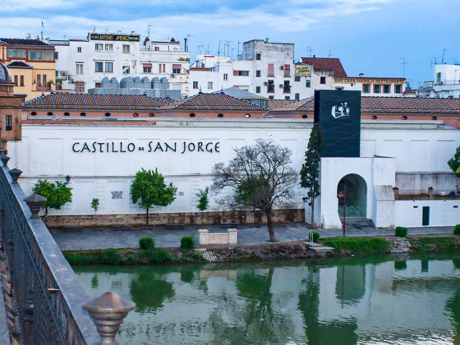 Exterior view of Castillo de San Jorge with a riverfront