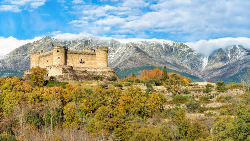 Aerial view of the Castle Mombeltrán with the mountain ranges in the background in Avila