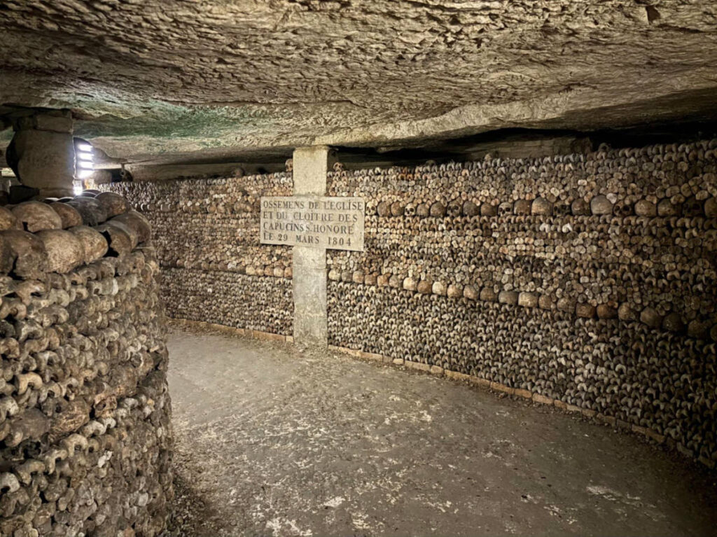 View of the skulls and bones stacked at The Catacombs in the 14th arrondissement