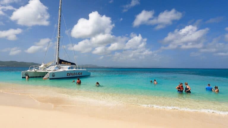 Tourists swimming near the docked Catamaran boat in US Virgin Islands