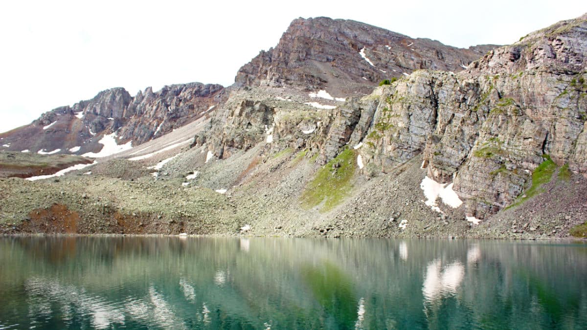 Scenic view of the Cathedral Lake below the rocky mountain