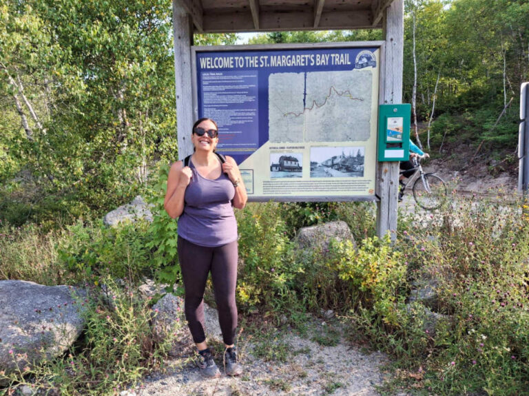 The author Catherine Driver, posing for a photo in front of the trail signage in Camino