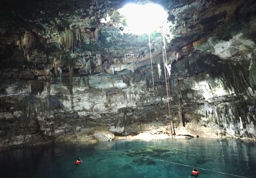 View of two people having a swim in Cenote Samula