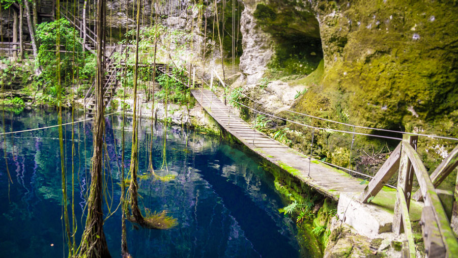 View of a small wooden bridge above the water of Cenote Xcanche