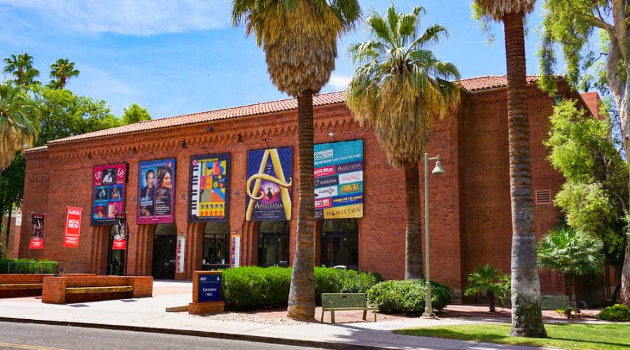 Façade of the brick walled Centennial Hall performing arts center on the campus of the University of Arizona