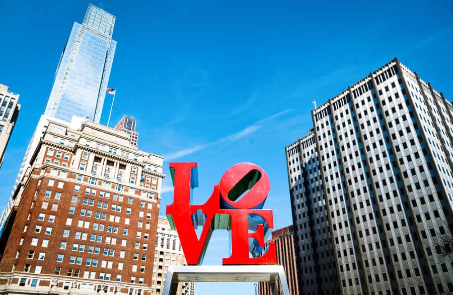 The red LOVE Park sign surrounded by tall buildings in downtown Philadelphia