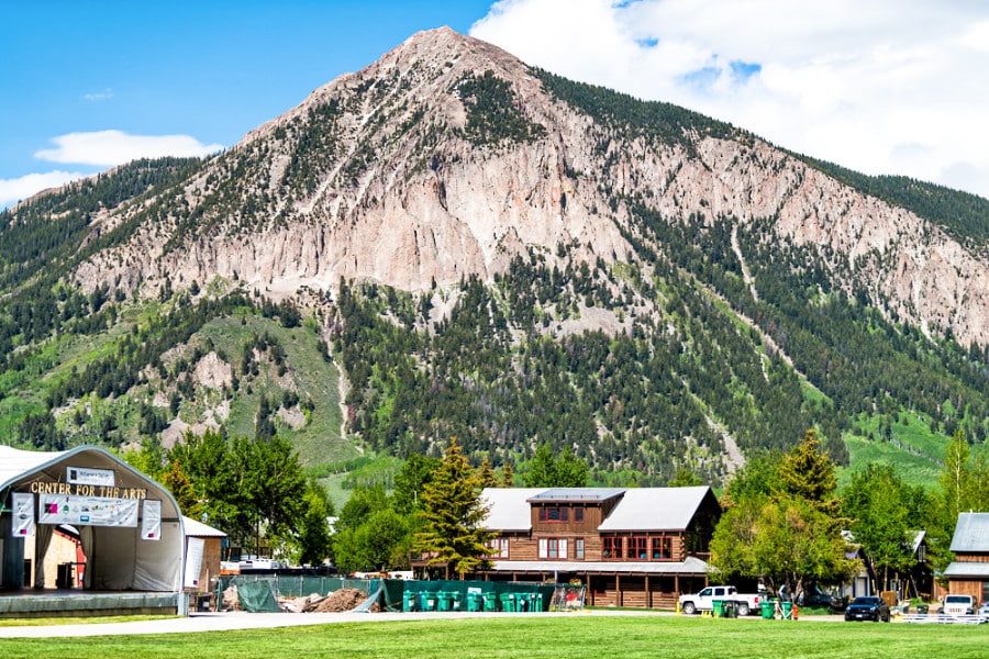 Landscape view of the Center for the Arts stage near a park with the mount Crested Butte in the background